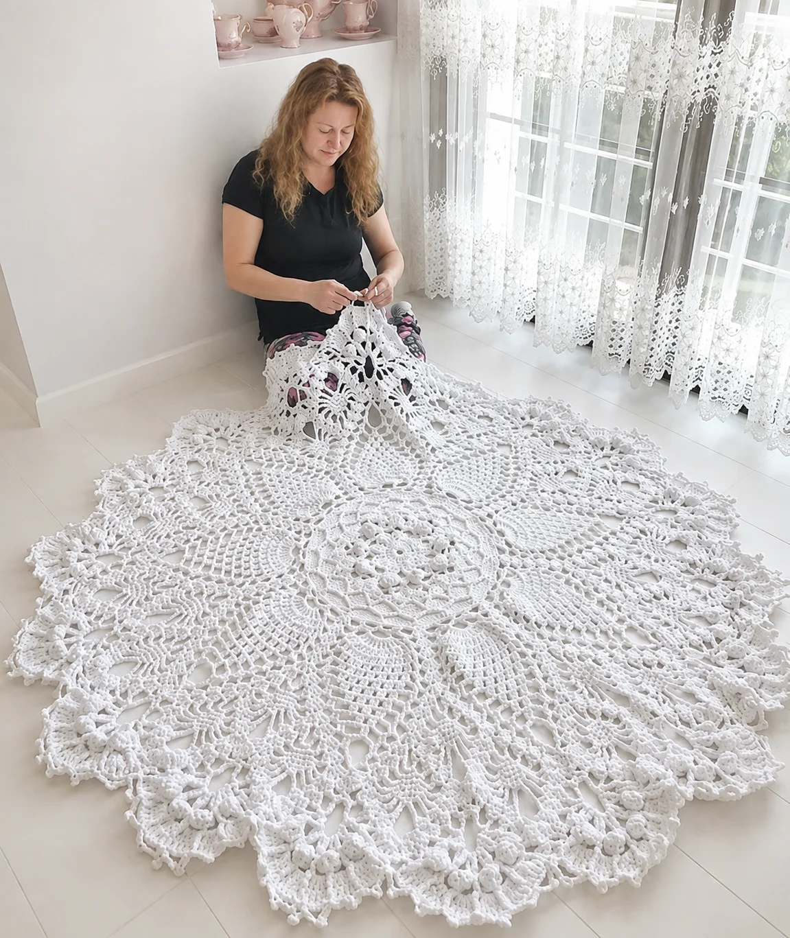 Maker working on a large crochet piece